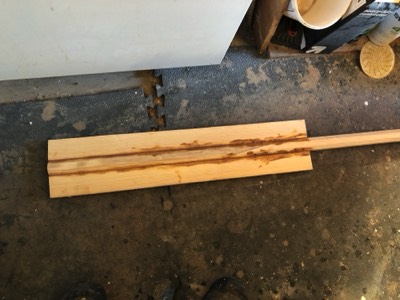  2/24/18 - pieces of spruce are epoxied to either side of the shaped oar shaft. 