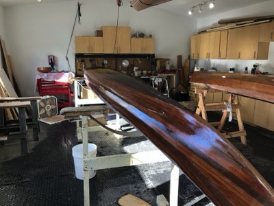  The first coat of varnish is applied to the hull. 