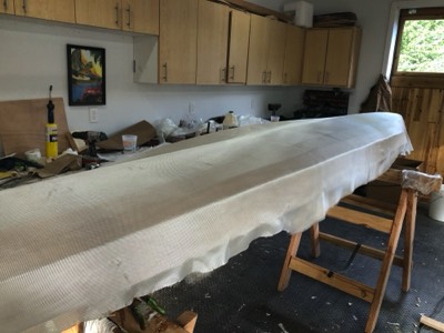  Fiberglass cloth is laid on the hull. 