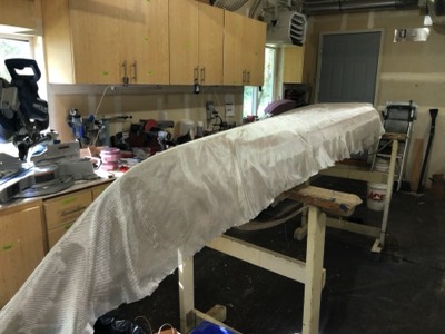  4/6/20 - Fiberglass cloth is laid on the hull. 