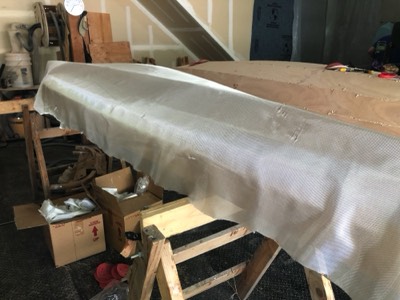  Fiberglass cloth is laid on the hull. 