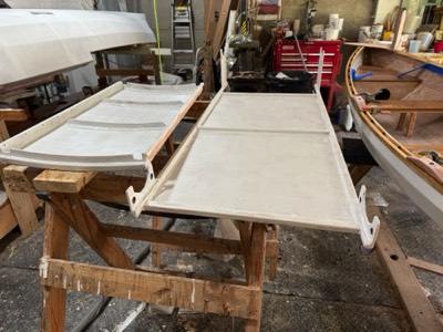  Primer is applied to the undersides of the main hatch and solar panel mount.  