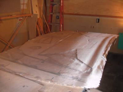  Fiberglass cloth is laid out.   