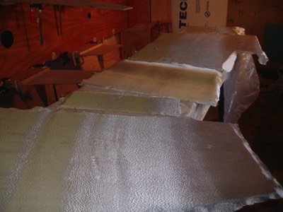  Fiberglass cloth is laid out on the foward sole, console parts, and driver's seat parts.   