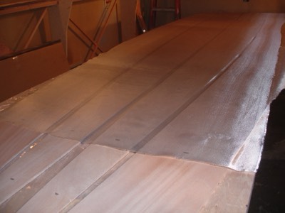  Fiberglass cloth is laid out on the panels.  The front tips do not get fiberglassed, only sealed with epoxy. 