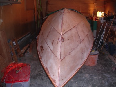  4/18/11 - The boat is flipped over!  There's a lot of sanding to come. 