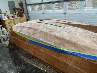  The varnish is sanded off in the area where bottom paint will be applied. 