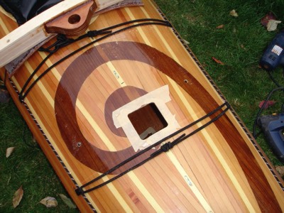  A hole (gulp!) is cut in the kayak for the mast.  This hole will act like a tiny hatch.  The hatch lip has a round mast sized hole.  