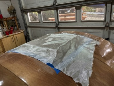  3/21/22 - Fibglass cloth is laid out on the hatch.  